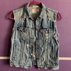 Distressed denim vest.